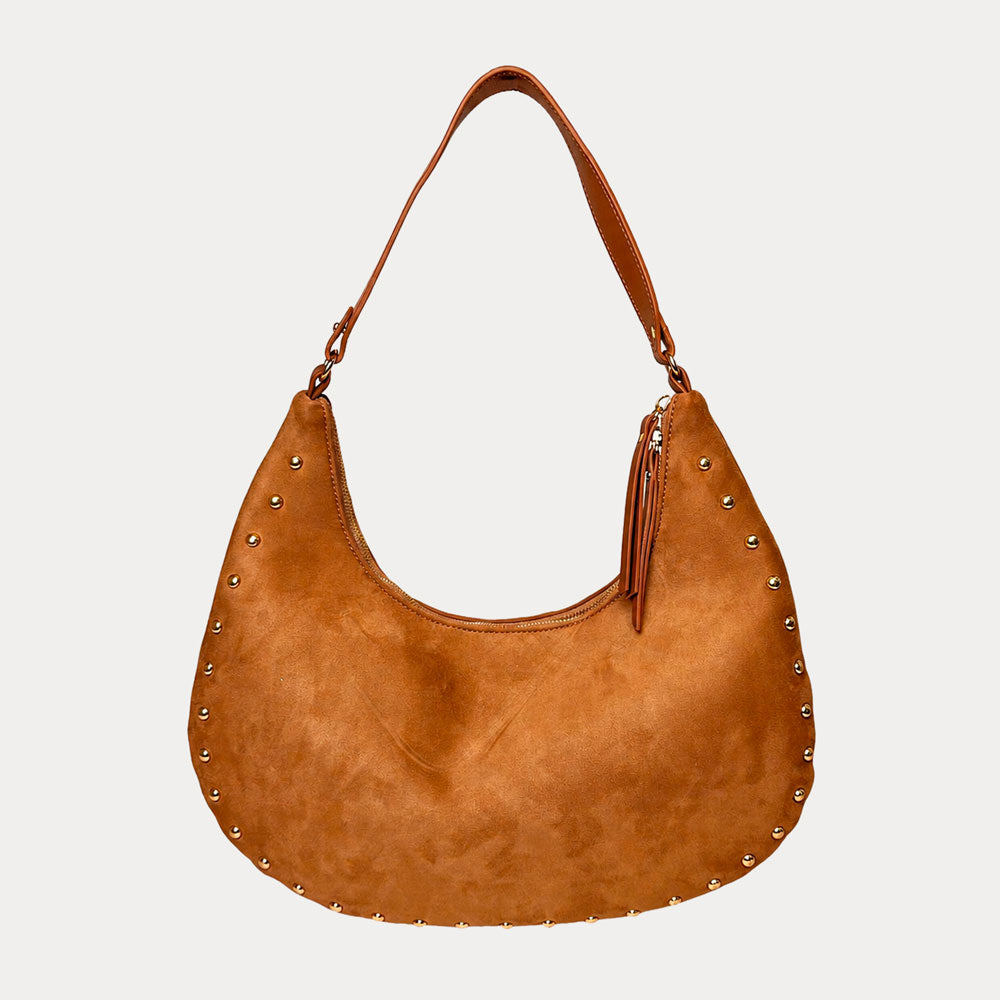 Camel vegan suede handbag with studs on a light gray background