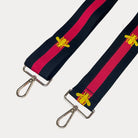 Black and red striped bag strap with embroidered yellow bees with gold hardware on a light gray background