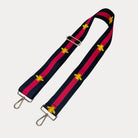 Black and red striped bag strap with embroidered yellow bees with gold hardware on a light gray background