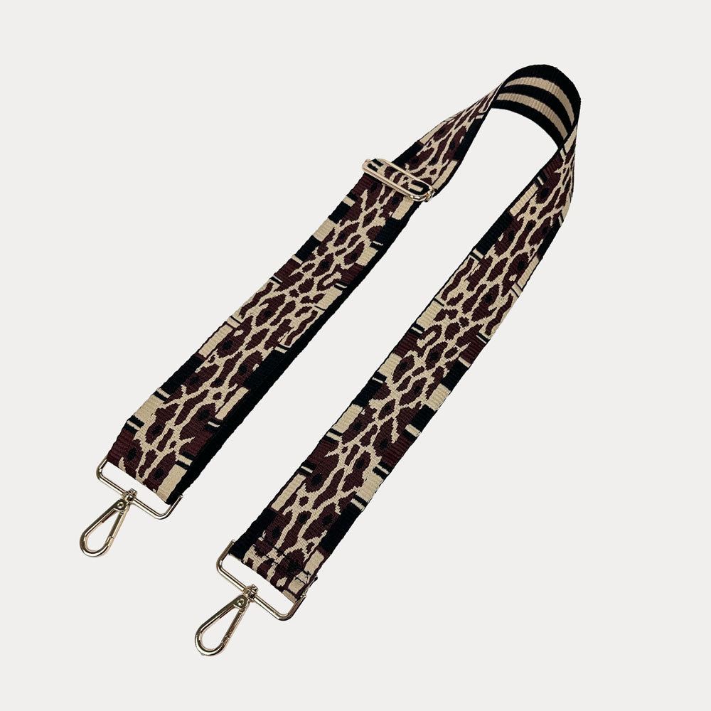 Leopard print bag strap on a light gray background