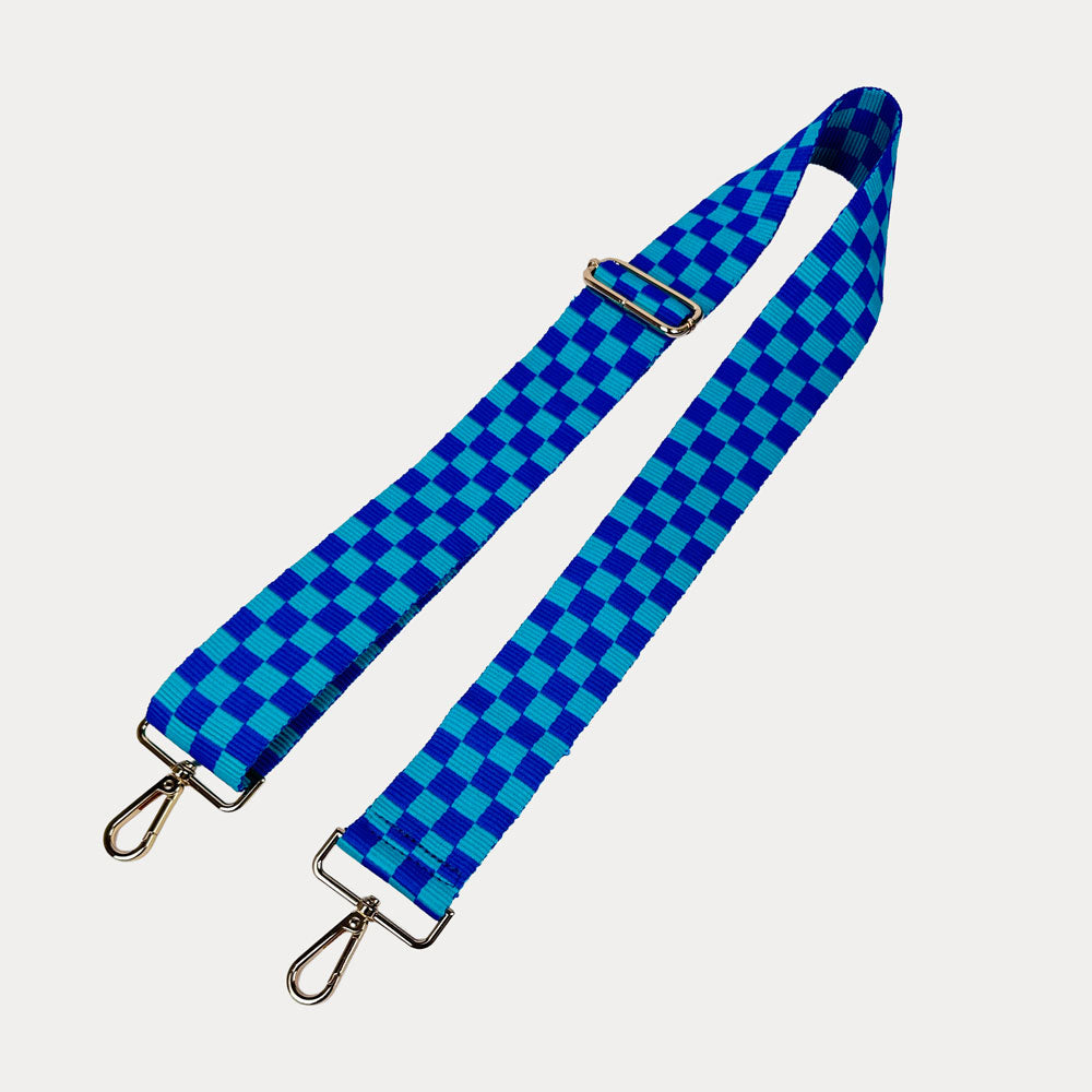 Blue and aqua checkered bag strap  with gold metal clasp trim on a white background
