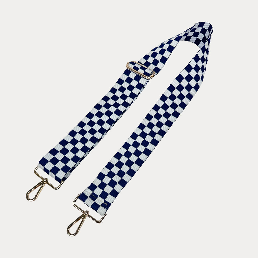 Navy and white checkered bag strap  with gold metal clasp trim on a white background
