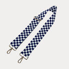 Navy and white checkered bag strap  with gold metal clasp trim on a white background
