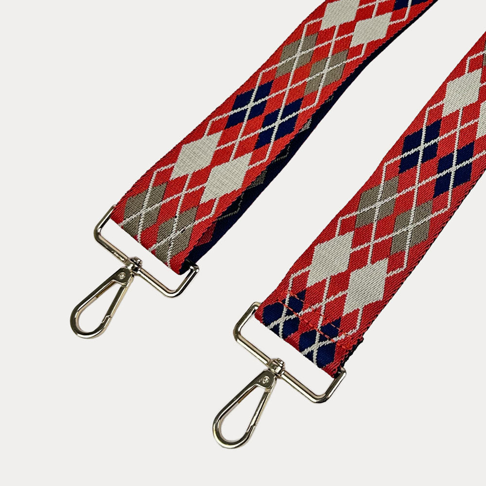 Orange, Navy, Cream Argyle Patterned Bag Strap with gold metal clasps on a white background