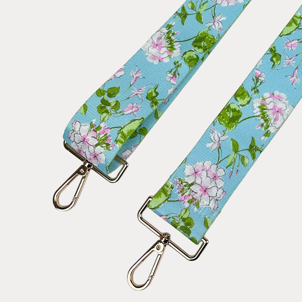 Aqua Ground Floral patterned strap with gold metal clasps on a white background