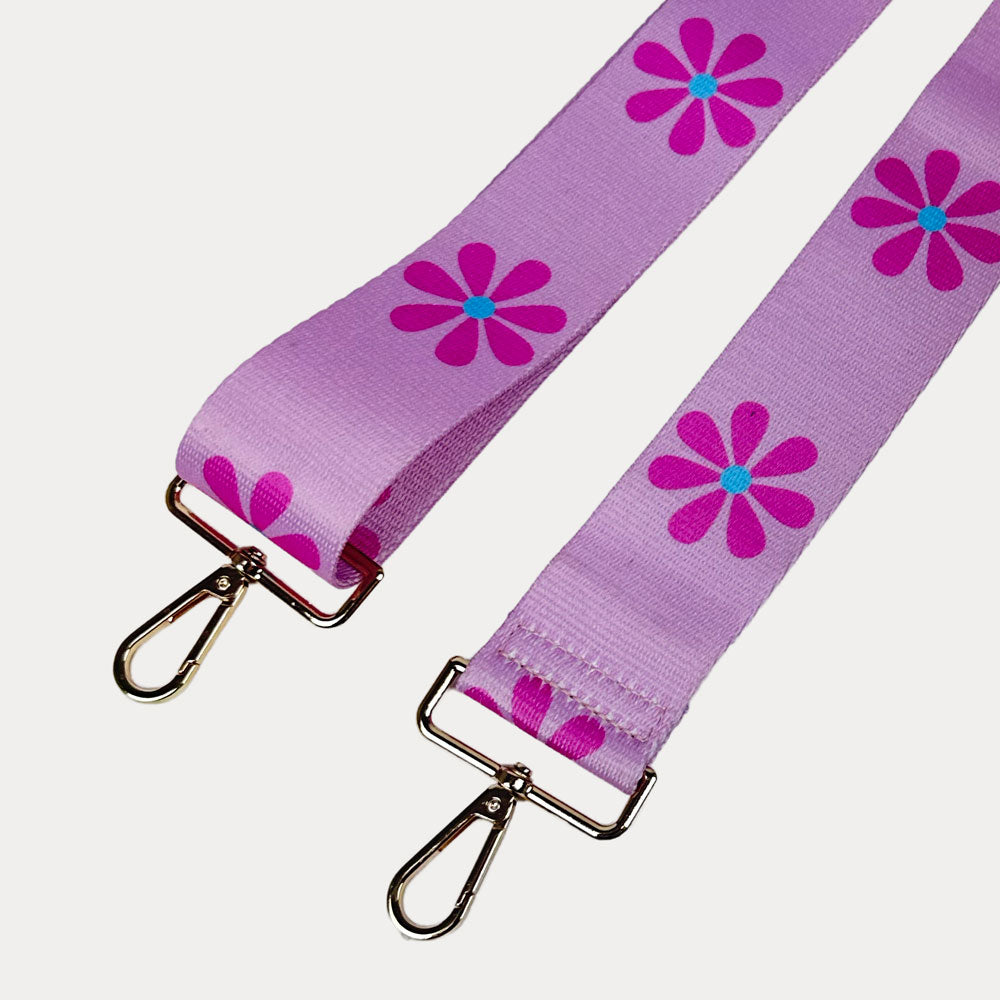 Pink ground with Pink Flower Print bag strap with gold metal clasps on light grey background