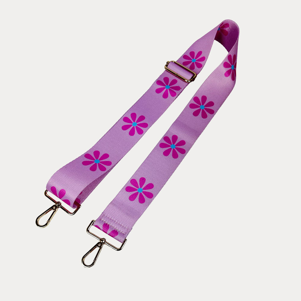 Pink ground with Pink Flower Print bag strap with gold metal clasps on light grey background