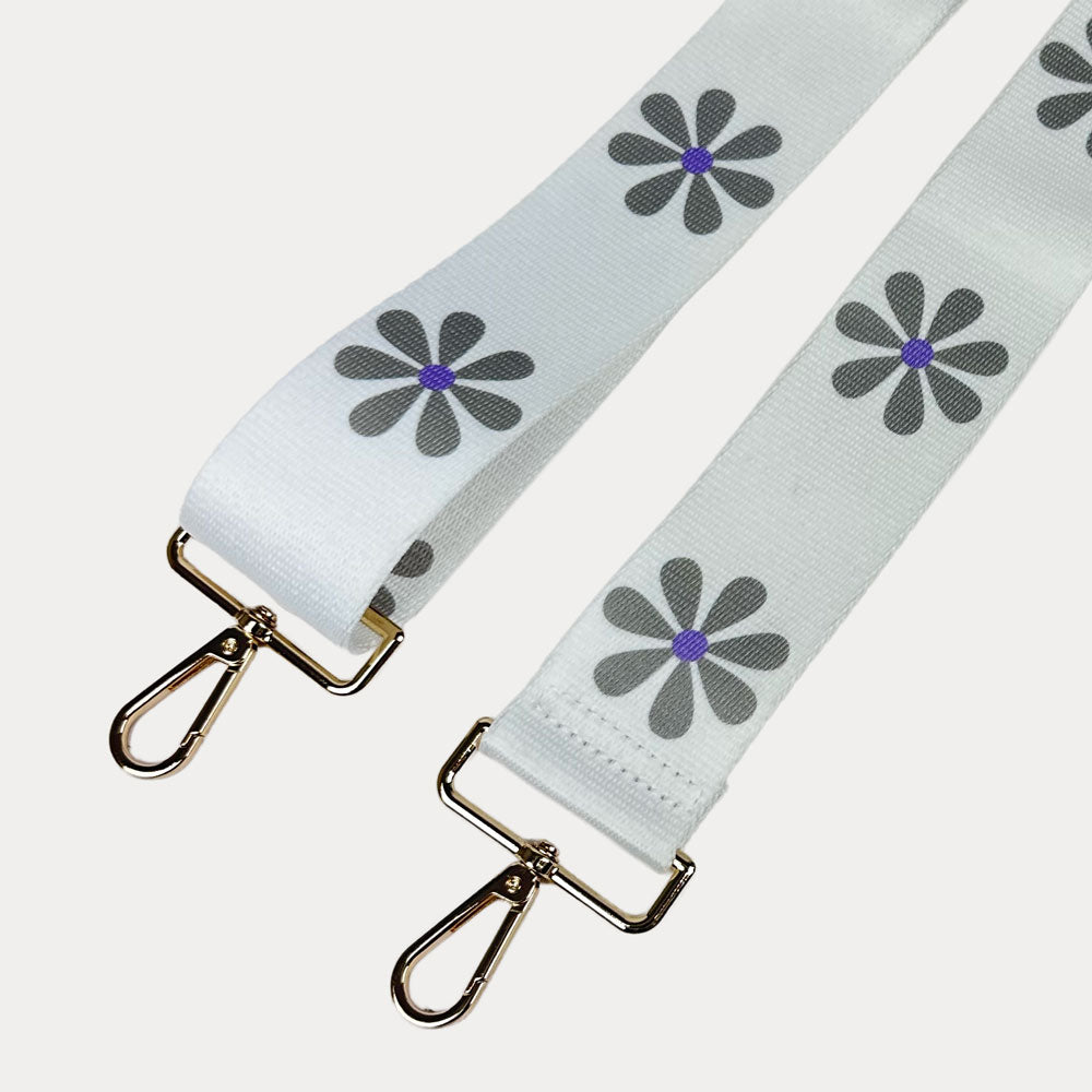 White ground with Grey Flower Print bag strap with gold metal clasps on light grey background