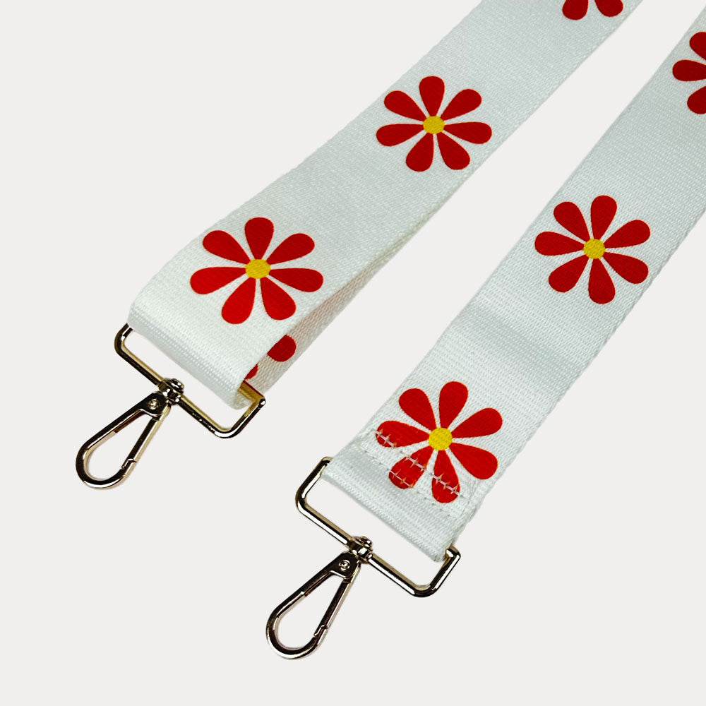 White ground with Orange Flower Print bag strap with gold metal clasps on light grey background