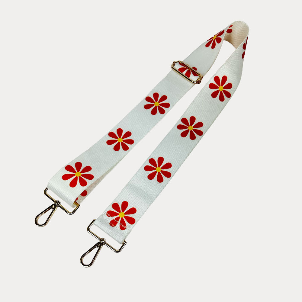 White ground with Orange Flower Print bag strap with gold metal clasps on light grey background
