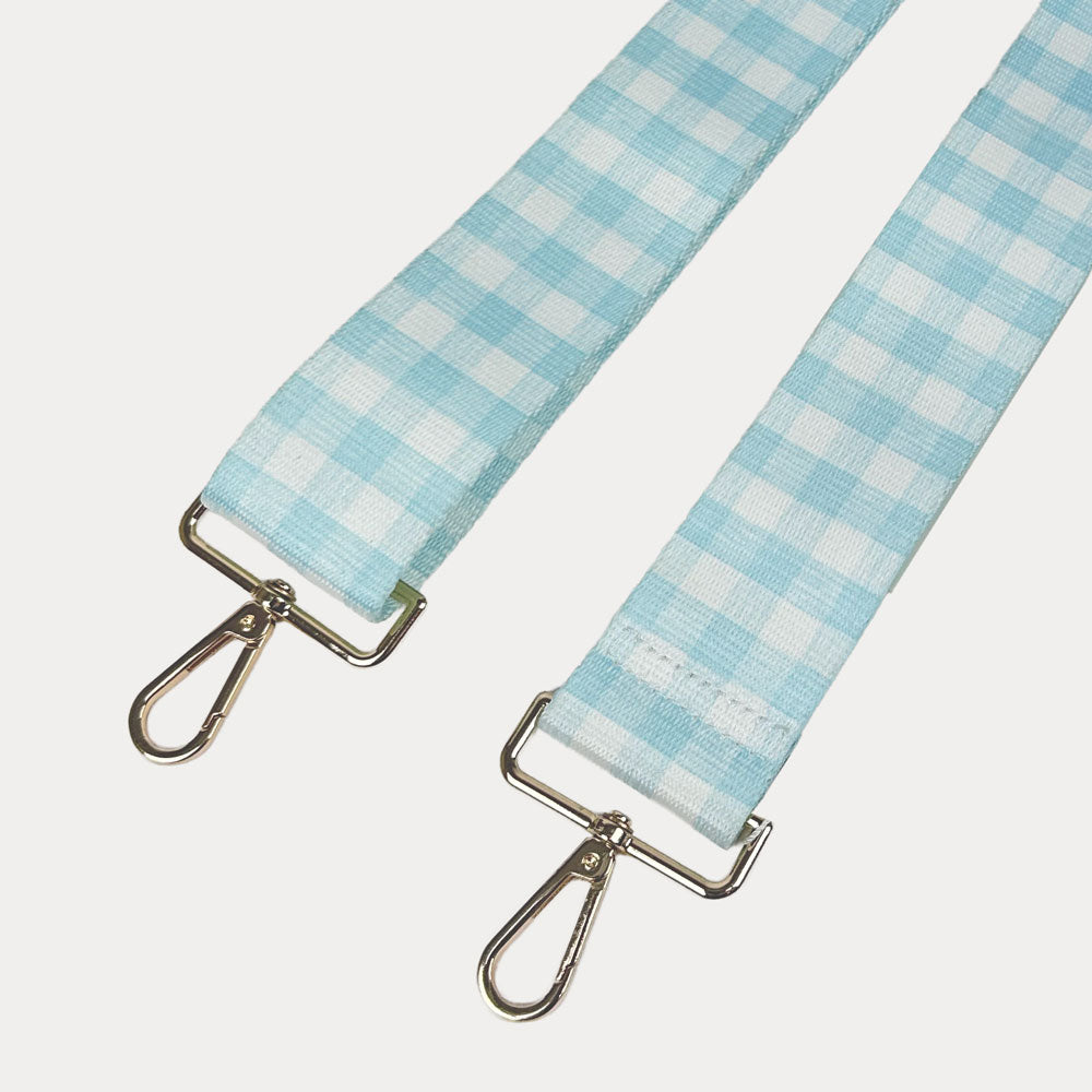 Aqua and white checkered strap with gold metal clasps on a light gray background