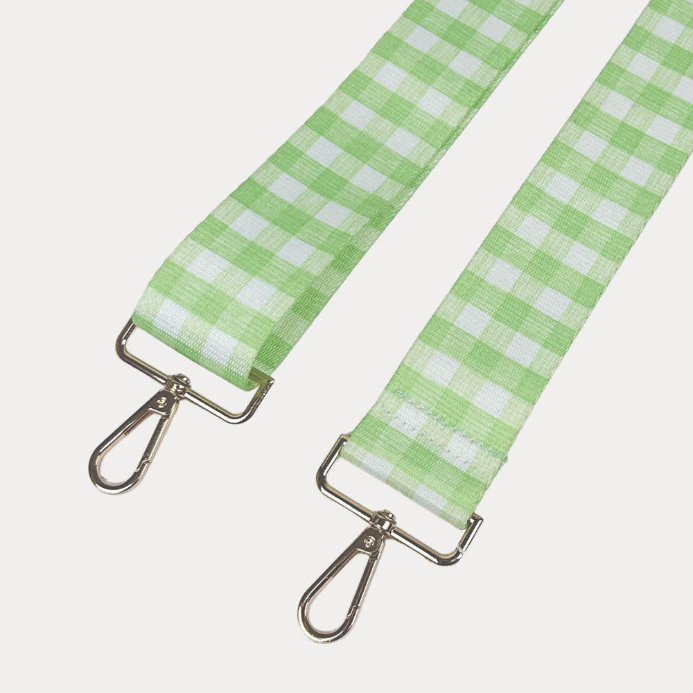 Lime and white checkered strap with gold metal clasps on a light gray background