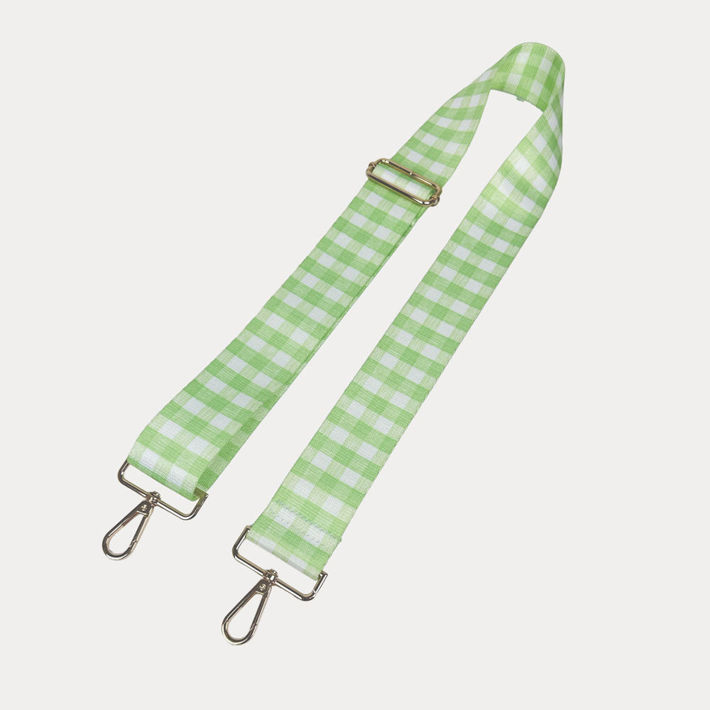 Lime and white checkered strap with gold metal clasps on a light gray background