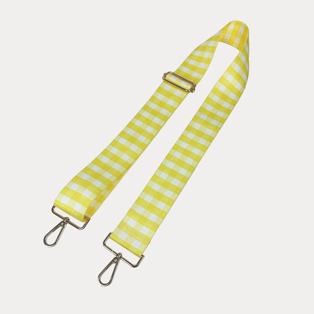 Yellow and white checkered strap with gold metal clasps on a light gray background