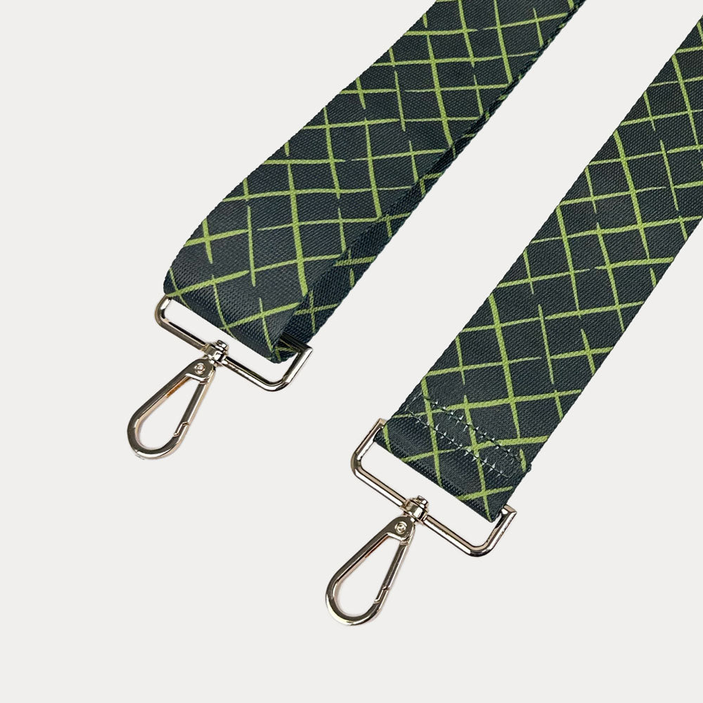 Army green and lime patterned strap with gold hardware on a white background