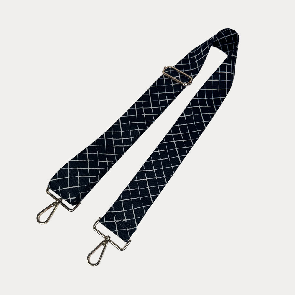 Black and white patterned strap with gold hardware on a white background
