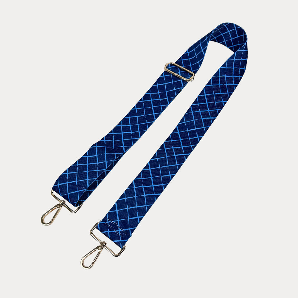 Navy and blue patterned strap with gold hardware on a white background