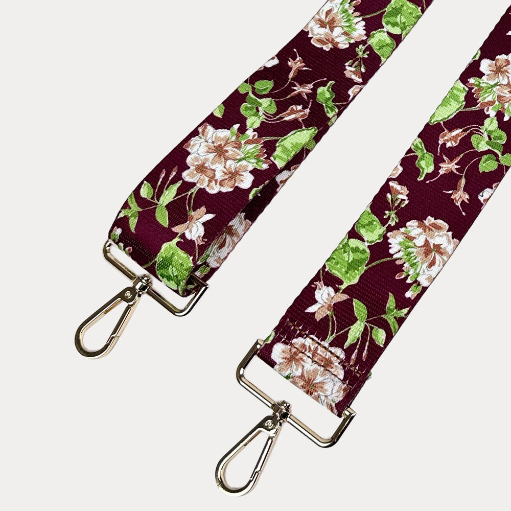 Burgundy Ground Floral patterned strap with gold metal clasps on a white background