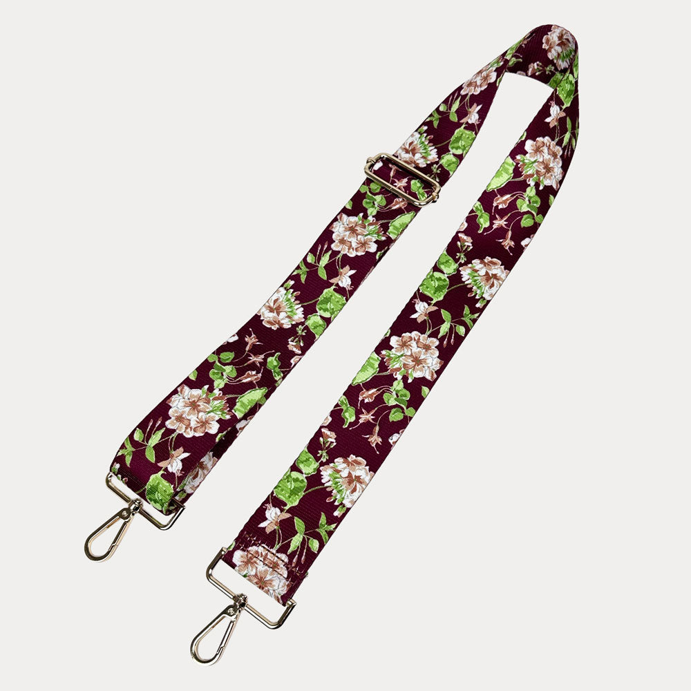 Burgundy Ground Floral patterned strap with gold metal clasps on a white background
