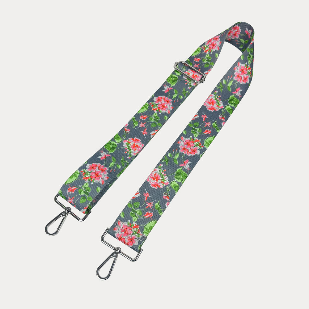 Grey ground floral patterned strap with silver hardware on a light gray background