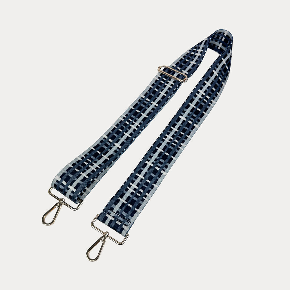 Black and grey plaid strap with gold metal hardware on a white background