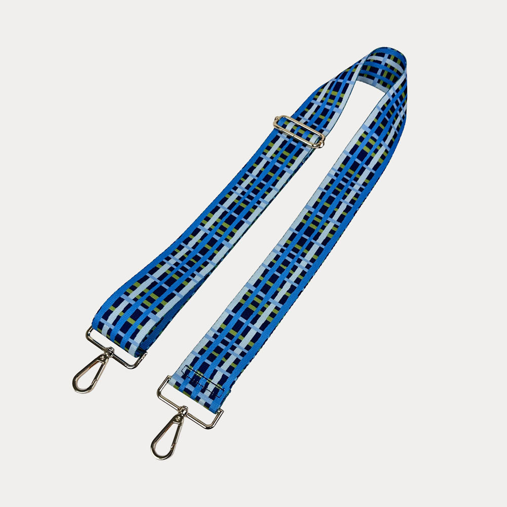 Navy, blue and green plaid strap with gold metal hardware on a white background