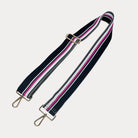 Black, White, and Pink striped bag strap with gold hardware light gray background