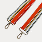 Orange, Grey, and White striped bag strap with gold hardware light gray background