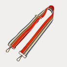 Orange, Grey, and White striped bag strap with gold hardware light gray background