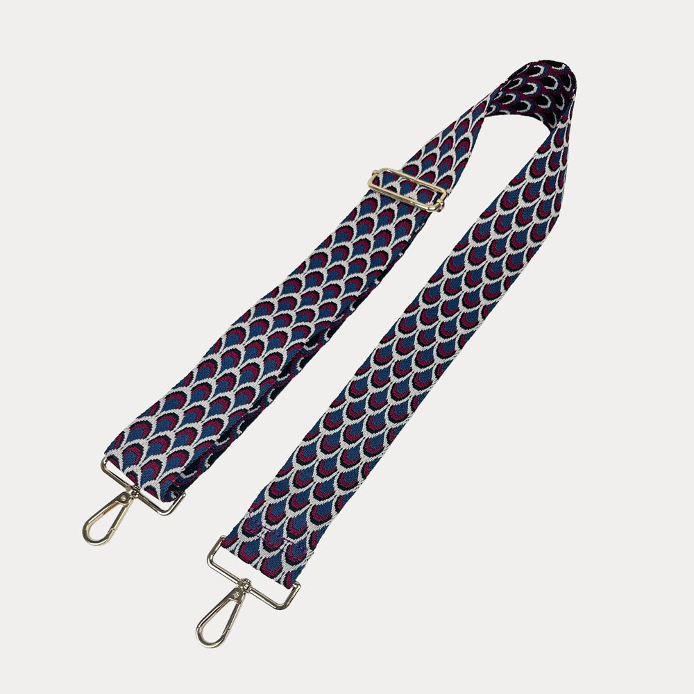 Blue, Burgundy, White patterned bag strap with gold hardware on a light gray background
