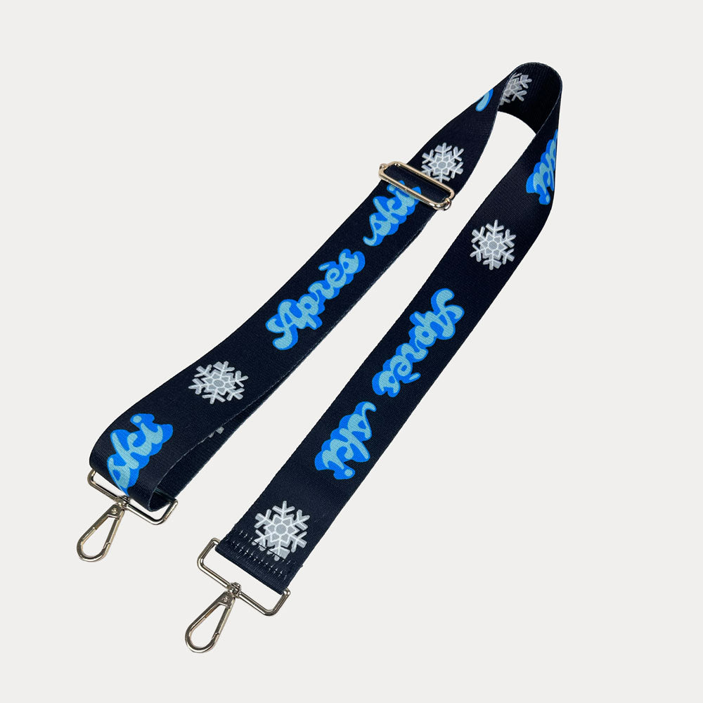 Black ground with Apres Ski text in Blue and white snowflakes printed bag strap with gold hardware