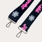 Black ground with Apres Ski text in Pink and white snowflakes printed bag strap with gold hardware