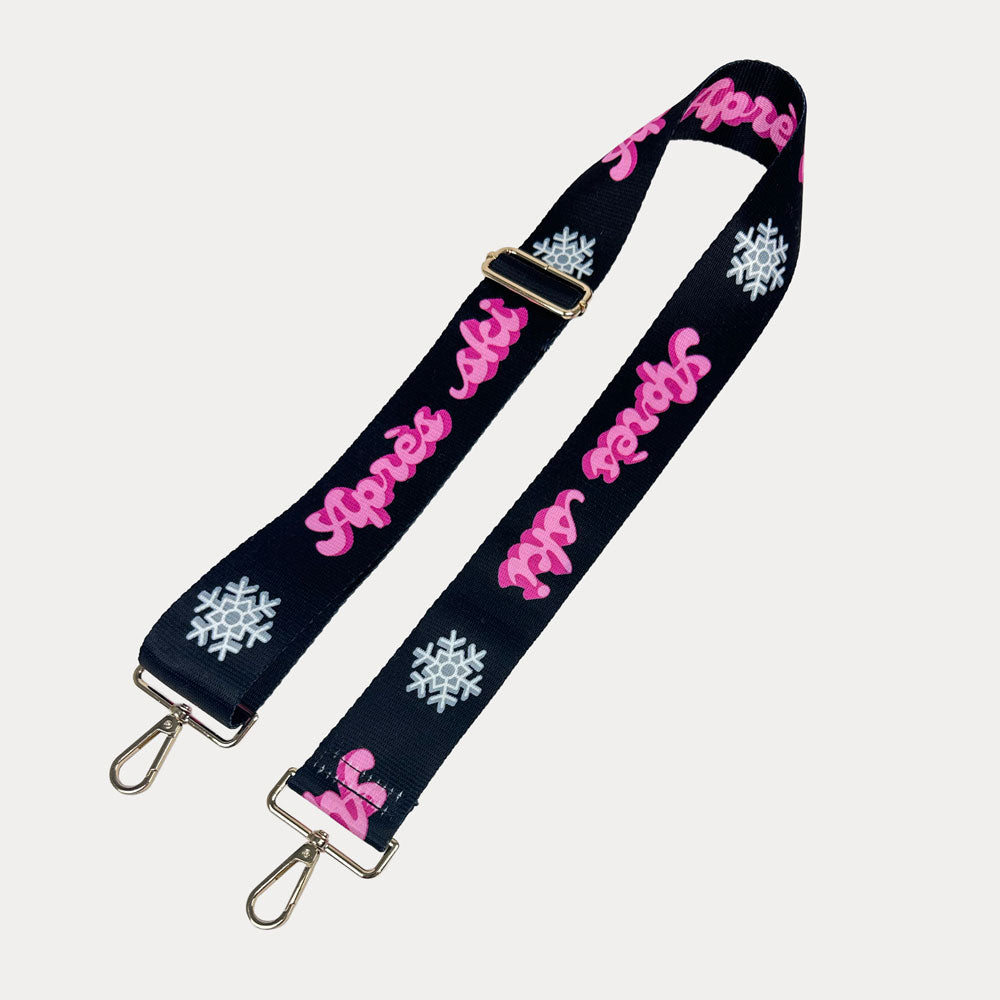 Black ground with Apres Ski text in Pink and white snowflakes printed bag strap with gold hardware
