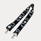 Black ground with text Golf graphics  with gold hardware bag strap