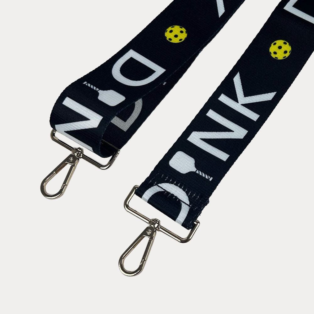 Black ground with Dink text with gold hardware bag strap