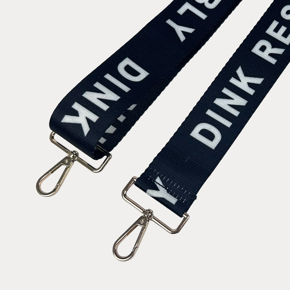 Black ground with Dink Responsibly text with gold hardware bag strap