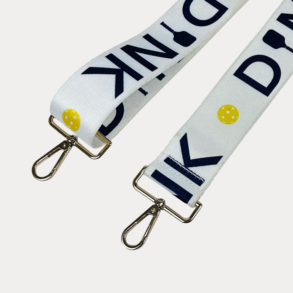 Black ground with Dink text with gold hardware bag strap