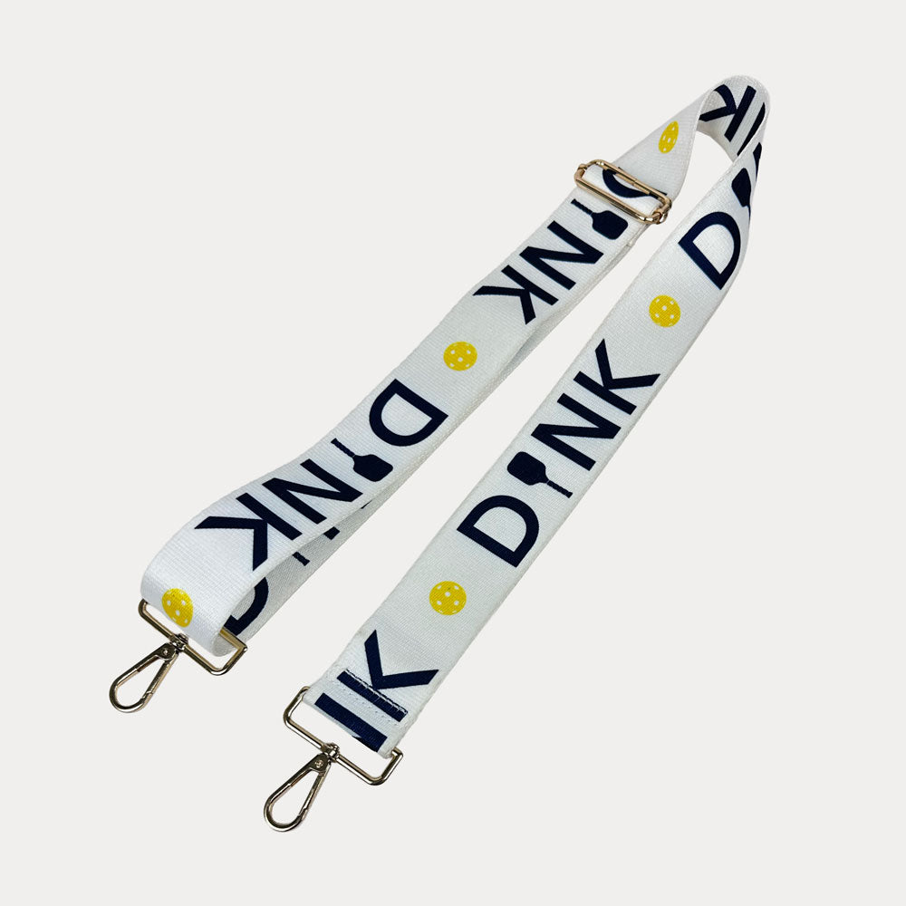 White ground with Dink text with gold hardware bag strap