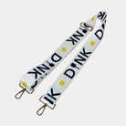 White ground with Dink text with gold hardware bag strap
