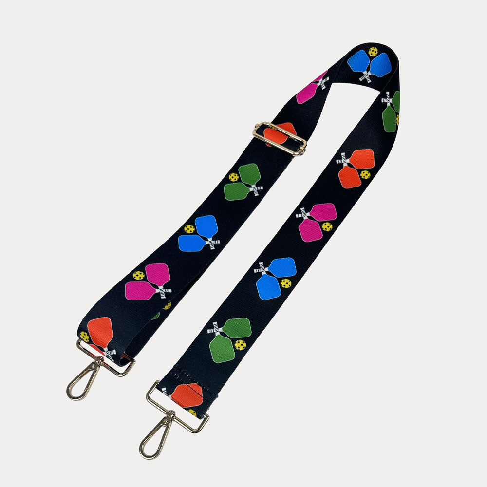 Black ground with colorful pickleball paddle graphics with gold hardware bag strap