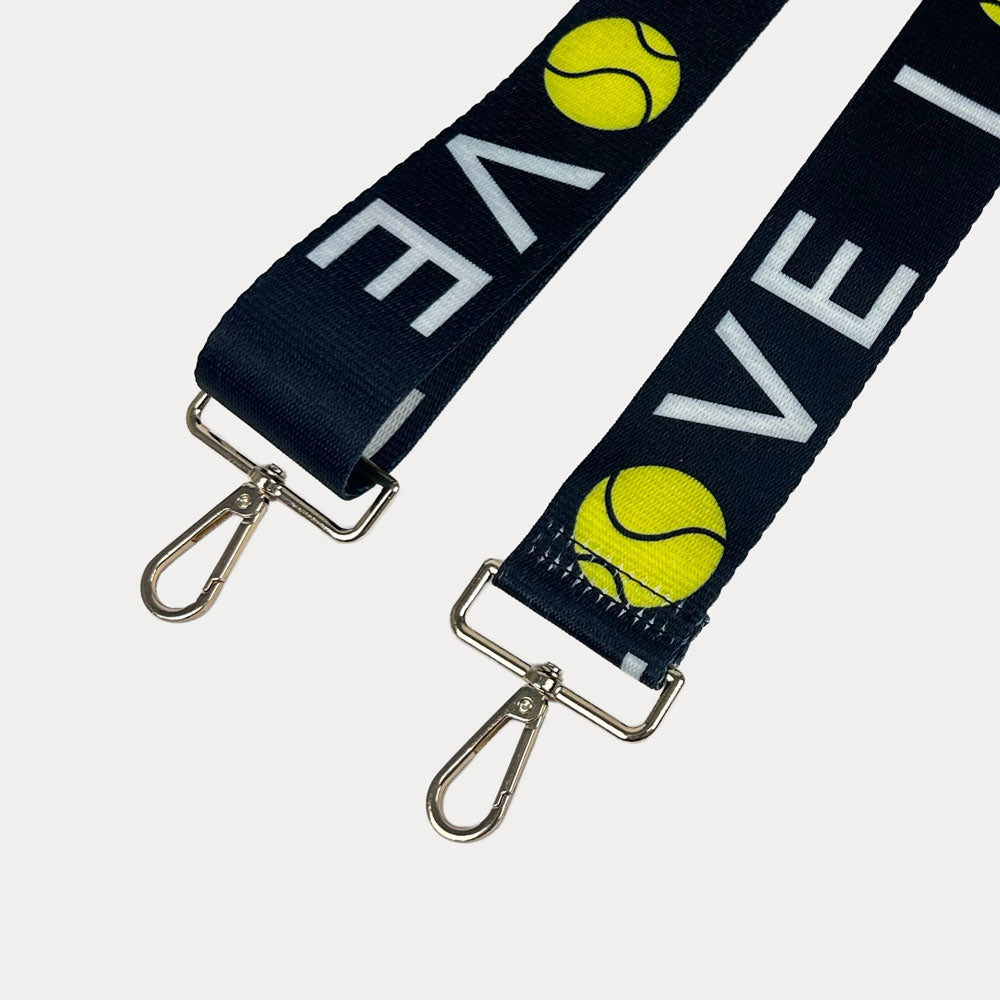 Black ground with 'LOVE' text and tennis ball graphics with gold hardware bag strap