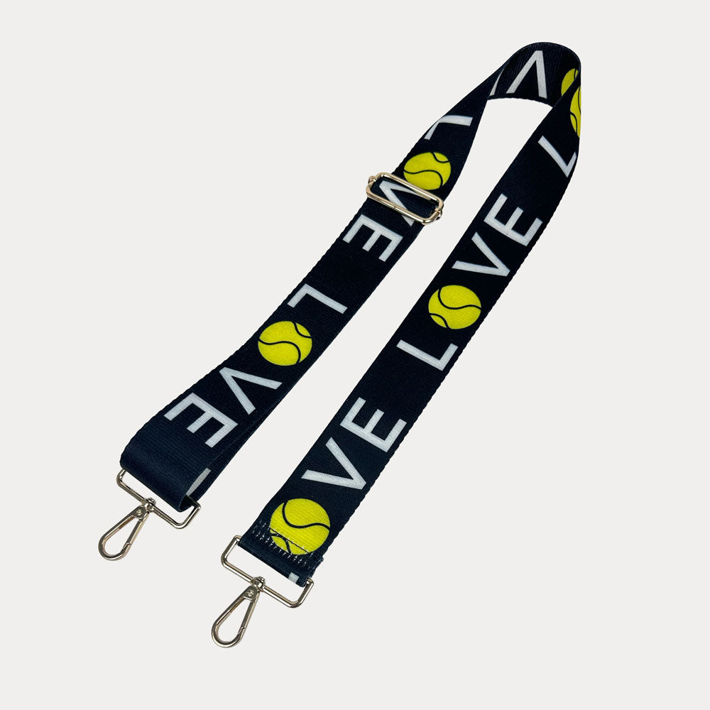 Black ground with 'LOVE' text and tennis ball graphics with gold hardware bag strap