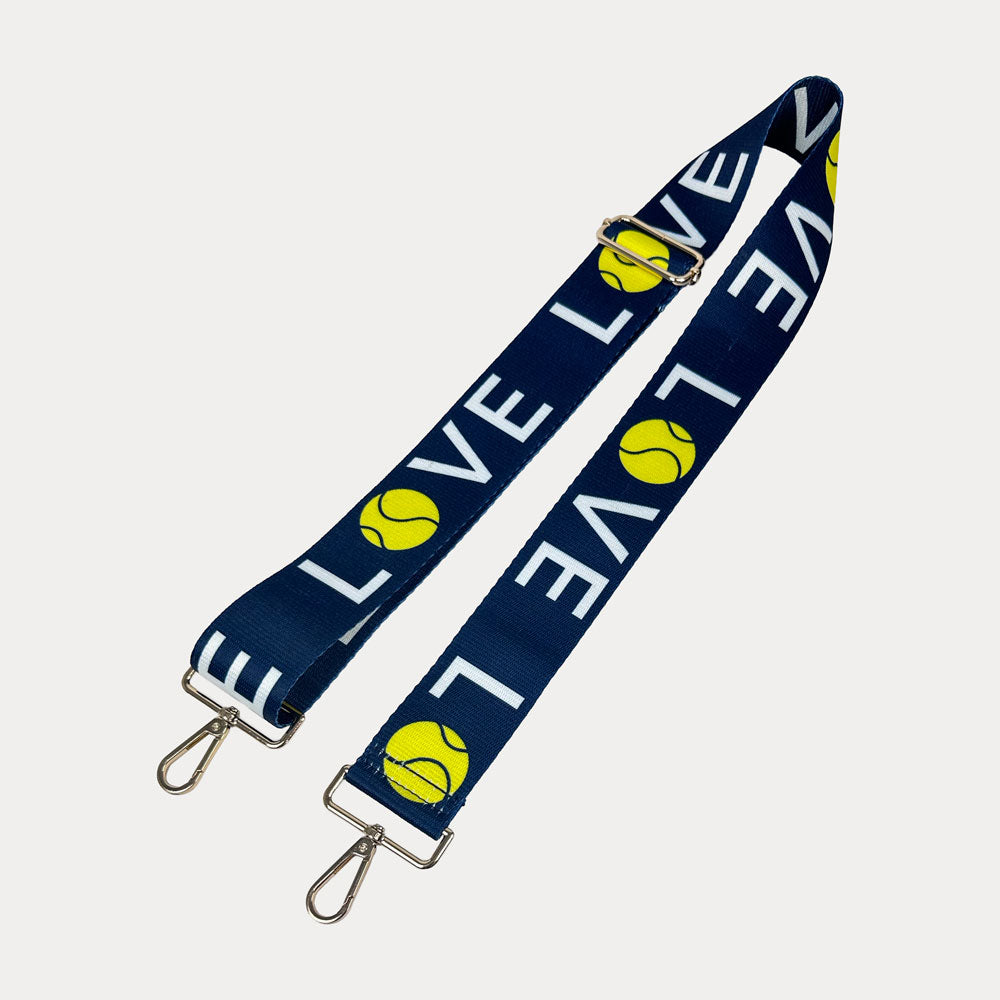 Navy ground with 'LOVE' text and tennis ball graphics with gold hardware bag strap