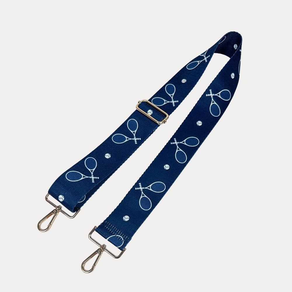 Navy ground with tennis racket graphics with gold hardware bag strap