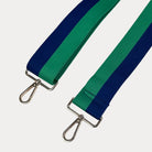 Green and Navy striped bag strap with gold hardware on a light gray background