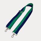 Green and Navy striped bag strap with gold hardware on a light gray background