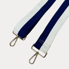 Navy and White striped bag strap with gold hardware on a light gray background