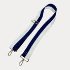 Navy and White striped bag strap with gold hardware on a light gray background