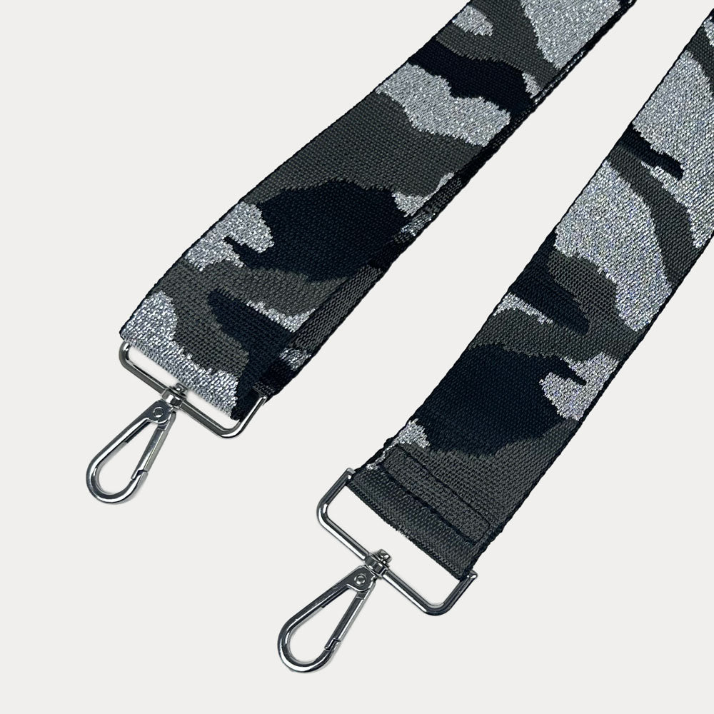 Black and gray camouflage patterned strap with silver metal clasps on a light gray background