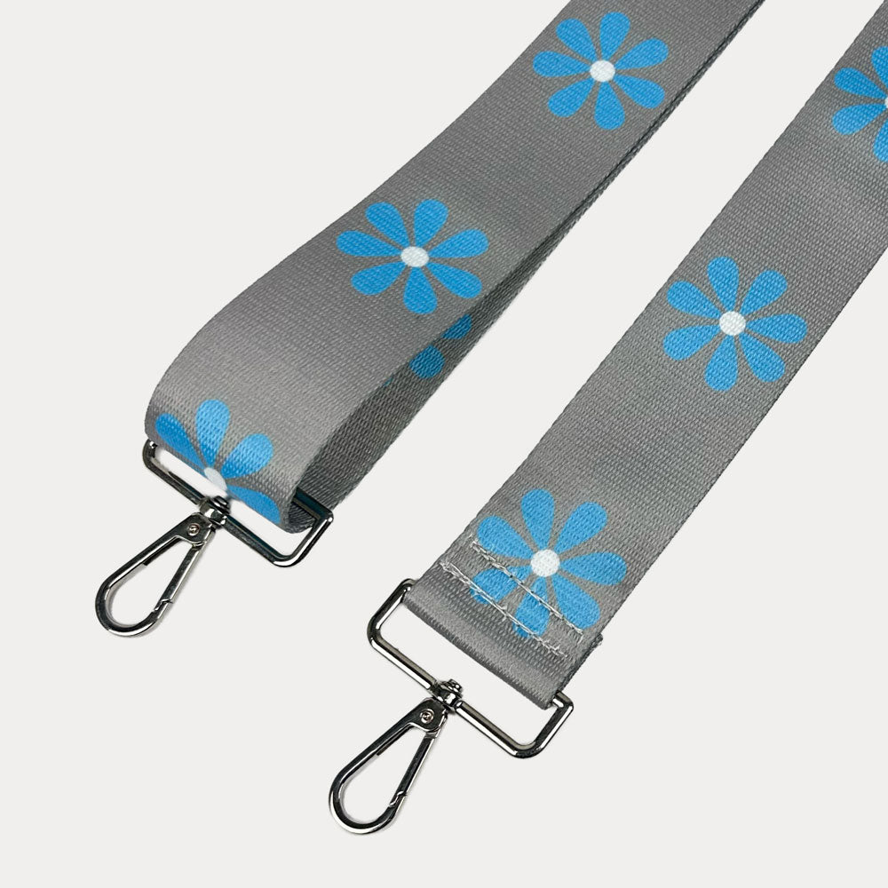Grey ground with Light Blue Flower Print bag strap with silver metal clasps on light grey background